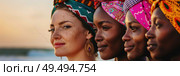 A group of women wearing headscarves stand next to each other. They are gathered in a row, displaying unity and solidarity. Стоковое AI-изображение, AI-художник Данила Большаков / Фотобанк Лори