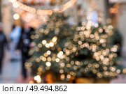 Beautiful Christmas background 2026.Abstract blurred Christmas background with Christmas tree garlands in warm shades. Стоковое фото, фотограф Photojuli / Фотобанк Лори