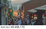 Kyoto, Japan - Sep 24 2024, 4k, panoramic view of street Kiyomizu-Zaka with many souvenir shops, tourists walking to temple of Pure Water Kiyomizu Dera, whose pagoda visible in distance, Kyoto, Japan. Редакционное видео, видеограф Сергей Богомяко / Фотобанк Лори