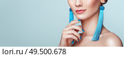 Beautiful woman with large earrings tassels jewelry blue color. Perfect makeup and nails manicure. Стоковое фото, агентство Ingram Publishing / Фотобанк Лори