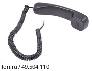 Чёрная телефонная трубка с витым проводом на белом фоне. A black handset with a twisted wire on a white background. Стоковое фото, фотограф Татьяна Д / Фотобанк Лори