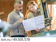 cabinet makers looking at project drawings. Стоковое фото, агентство Ingram Publishing / Фотобанк Лори