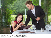 waiter giving suggestion to the customer. Стоковое фото, агентство Ingram Publishing / Фотобанк Лори