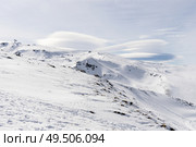 Spain, Andalusia, Granada. Ski resort of Sierra Nevada in winter, full of snow with lenticular clouds in the sky. Travel and sports concepts.. Ski resort of Sierra Nevada in winter, full of snow. Стоковое фото, агентство Ingram Publishing / Фотобанк Лори