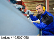 a factory worker is busy at work. Стоковое фото, агентство Ingram Publishing / Фотобанк Лори