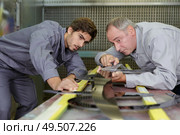 worker cuts metal sheet with a cutter. Стоковое фото, агентство Ingram Publishing / Фотобанк Лори