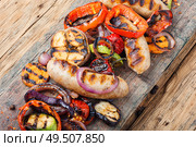 Grilled sausages fried with pear and vegetables. Autumn food.. Delicious sausages and vegetables. Стоковое фото, агентство Ingram Publishing / Фотобанк Лори