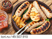 Grilled sausages fried with pear and.Autumn food.Grill menu. Grilled sausages on wooden board. Стоковое фото, агентство Ingram Publishing / Фотобанк Лори