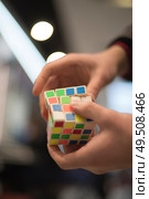 man collects the cube rubik. Intellectual puzzle. Редакционное фото, агентство Ingram Publishing / Фотобанк Лори