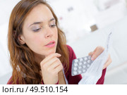 young woman reading medication prescription. Стоковое фото, агентство Ingram Publishing / Фотобанк Лори