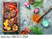 Grilled beef with vegetables to the Christmas table.Veal in pomegranate sauce.Christmas dinner. Christmas roast meat. Стоковое фото, агентство Ingram Publishing / Фотобанк Лори