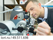 male engineer making adjustment to machine. Стоковое фото, агентство Ingram Publishing / Фотобанк Лори