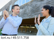 man speaking on phone and woman next to him. Стоковое фото, агентство Ingram Publishing / Фотобанк Лори