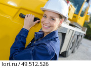 Portrait of woman at cab of heavy plant vehicle. Стоковое фото, агентство Ingram Publishing / Фотобанк Лори
