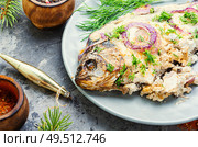 Baked fish at the Christmas table.Holiday food.Baked crucian.Fish food.. Baked fish for christmas. Стоковое фото, агентство Ingram Publishing / Фотобанк Лори
