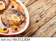 Ossobuco, traditional dish of Italian cuisine. Stewed veal leg.Italian food. Christmas meat cooked in apricot sauce. Стоковое фото, агентство Ingram Publishing / Фотобанк Лори