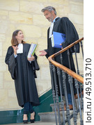 portrait of attorneys talking while walking. Стоковое фото, агентство Ingram Publishing / Фотобанк Лори
