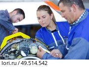 group of people during engine assembling. Стоковое фото, агентство Ingram Publishing / Фотобанк Лори