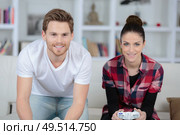 young couple having fun playing videogame at home. Стоковое фото, агентство Ingram Publishing / Фотобанк Лори