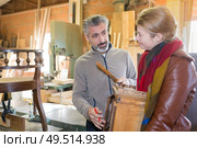 woman choosing tabletop in furniture store. Стоковое фото, агентство Ingram Publishing / Фотобанк Лори