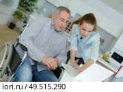 old man in geriatric hospice helped by young attractive woman. Стоковое фото, агентство Ingram Publishing / Фотобанк Лори