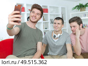 portrait of three university students taking a selfie at home. Стоковое фото, агентство Ingram Publishing / Фотобанк Лори