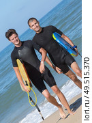 two handsome guys ready for surfing. Стоковое фото, агентство Ingram Publishing / Фотобанк Лори