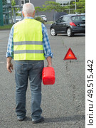 senior aged man holding gas can to refill his car. Стоковое фото, агентство Ingram Publishing / Фотобанк Лори