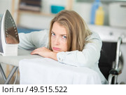 upset young woman in wheelchair ironing. Стоковое фото, агентство Ingram Publishing / Фотобанк Лори