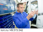 a mechanic is assessing part. Стоковое фото, агентство Ingram Publishing / Фотобанк Лори