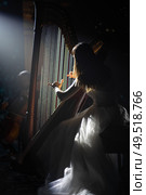 girl playing the harp on stage during a concert. Стоковое фото, агентство Ingram Publishing / Фотобанк Лори