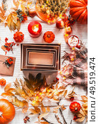 Autumnal flat lay with empty kraft paper boxes, scarf, autumn leaves, pumpkins, candles and cappuccino, top view. Fashion or beauty box. Place for your product. Insta style.  Eco friendly packaging. Стоковое фото, агентство Ingram Publishing / Фотобанк Лори