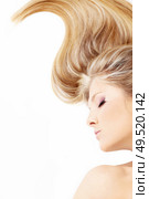 Close up of a bent fair hair and face of lying blonde, isolated. Стоковое фото, агентство Ingram Publishing / Фотобанк Лори