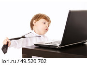 Llittle boy tries to remove a tie in an impulse of disgust for the work, isolated. Стоковое фото, агентство Ingram Publishing / Фотобанк Лори
