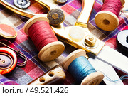 Sewing tools, scissors, buttons and threads on fabric.Sew. Sewing accessories and fabric. Стоковое фото, агентство Ingram Publishing / Фотобанк Лори