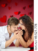 Enamoured man kisses hands of the beautiful woman. Стоковое фото, агентство Ingram Publishing / Фотобанк Лори