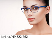 Woman with long eyelashes in eyeglasses. Vision correction. Poor eyesight. Spectacle frame. Makeup, cosmetics, beauty. Close up, macro. Стоковое фото, агентство Ingram Publishing / Фотобанк Лори