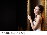 The beautiful girl with a make-up at a gold door. Стоковое фото, агентство Ingram Publishing / Фотобанк Лори