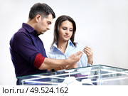 The buyer and the seller choose a jewel. Стоковое фото, агентство Ingram Publishing / Фотобанк Лори