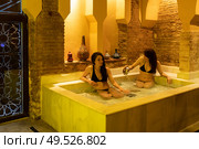 Two women enjoying Arabic baths Hammam in Granada, Andalusia, Spain. Elvira baths. Cold water pool. Two women enjoying Arabic baths Hammam in Granada. Стоковое фото, агентство Ingram Publishing / Фотобанк Лори