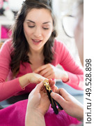 portrait of woman during shellac manicure. Стоковое фото, агентство Ingram Publishing / Фотобанк Лори