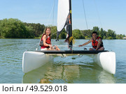 a couple in a sailboat. Редакционное фото, агентство Ingram Publishing / Фотобанк Лори