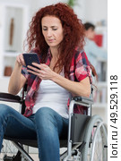 beautiful caucasian disabled woman sitting wheel chair. Стоковое фото, агентство Ingram Publishing / Фотобанк Лори