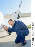 portrait of man fixing aircrafts minor defect. Стоковое фото, агентство Ingram Publishing / Фотобанк Лори