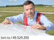 portrait of a pilot inspecting sailplane. Стоковое фото, агентство Ingram Publishing / Фотобанк Лори