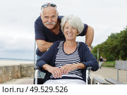 senior couple in wheelchair enjoying the sea. Стоковое фото, агентство Ingram Publishing / Фотобанк Лори