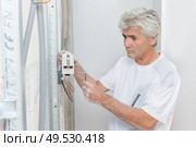 an artisan checking house wiring. Стоковое фото, агентство Ingram Publishing / Фотобанк Лори