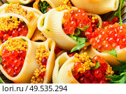 Festive, banquet pasta dish stuffed with red caviar.Macaroni stuffed with salmon caviar.. Red caviar filled pasta. Стоковое фото, агентство Ingram Publishing / Фотобанк Лори