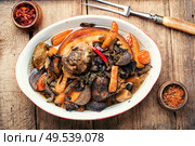 Roasted pork knuckle eisbein with vegetables on wooden background.Braised pork leg. Roasted pork knuckle. Стоковое фото, агентство Ingram Publishing / Фотобанк Лори