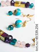 gold jewerly braslete with semiprecious and cristal at white background. Стоковое фото, агентство Ingram Publishing / Фотобанк Лори